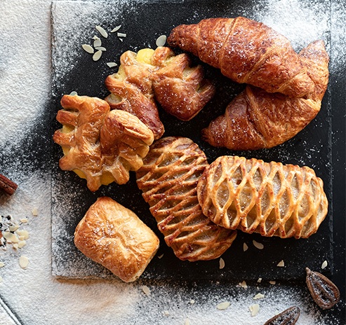 photo of a delicious croissants with figs, nuts and cheeses